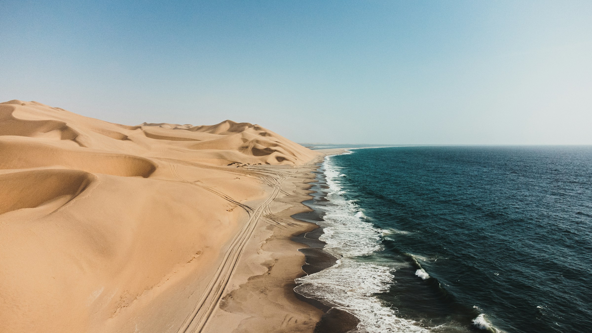 Golden Namib dunes beside the Atlantic Ocean